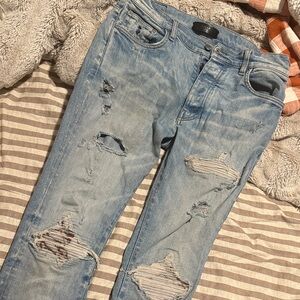 AMIRI Light Blue Denim Jeans with Black Leather Label